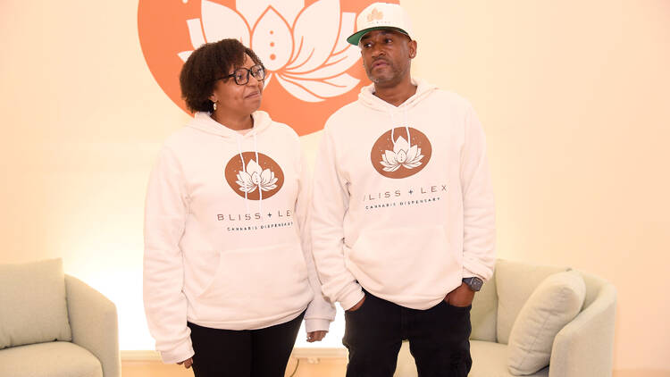two people stand in a dispensary