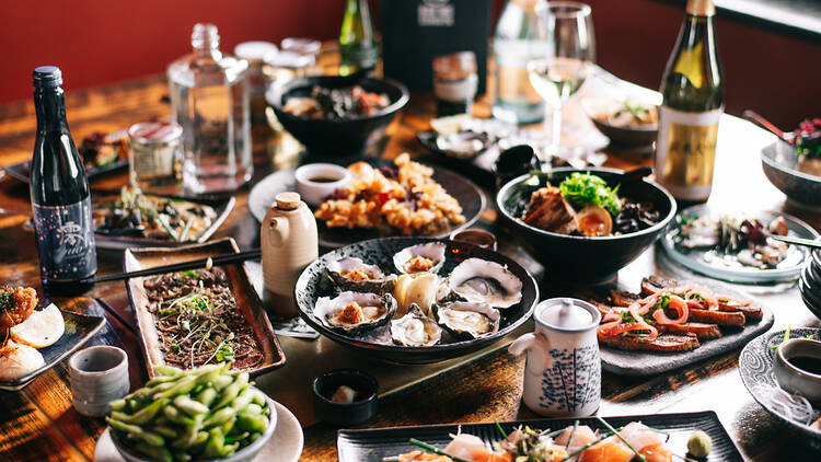 overlay of japanese food and drinks on the table