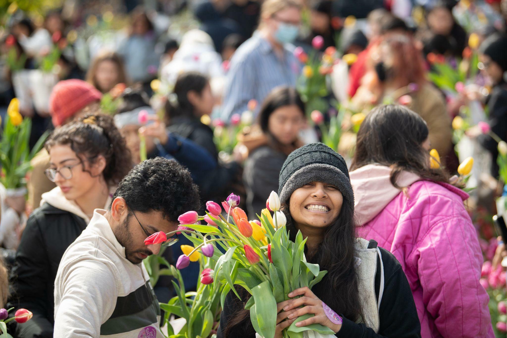 people take flowers at a market