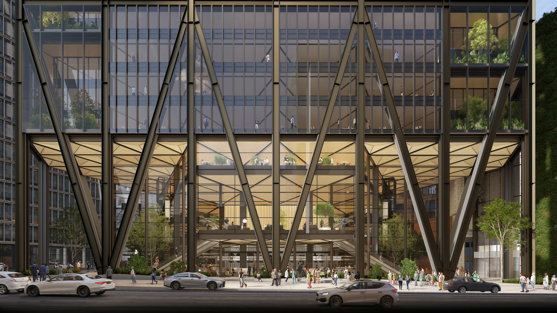 The ground floor of a glass building with trees inside. 