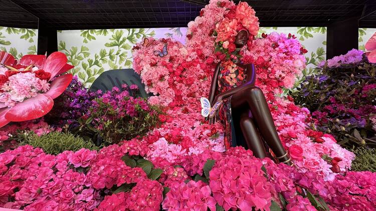 A pink floral display inside the Macy's windows for the spring flower show.