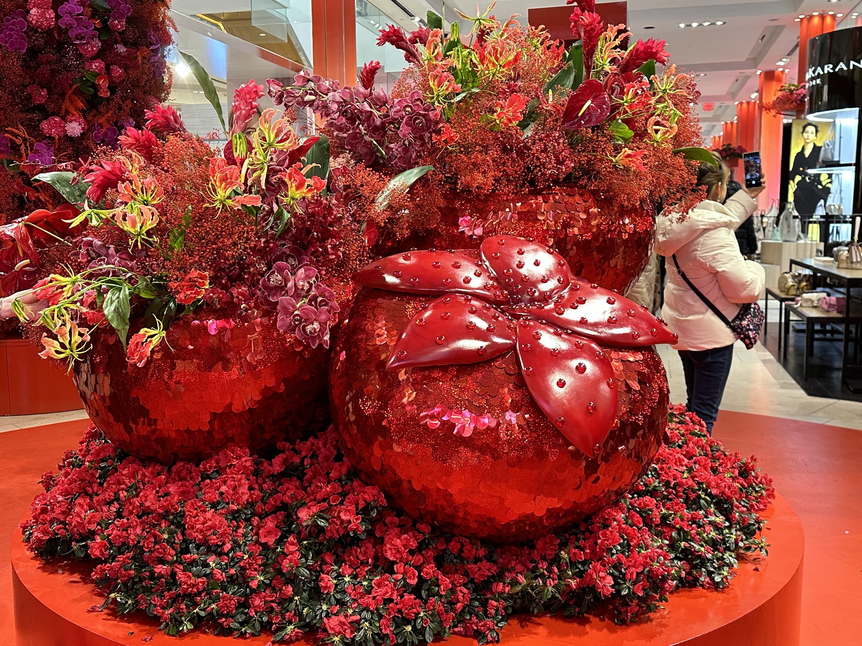 A display of glittery pink strawberries with burgundy orchids.