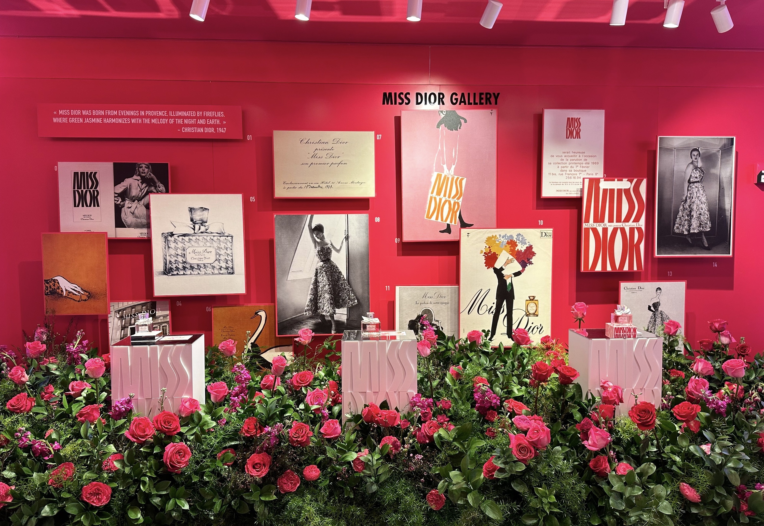 A Miss Dior display bedecked with pink roses.