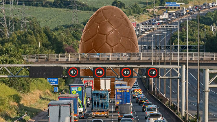 a large easter Egg over a motorway