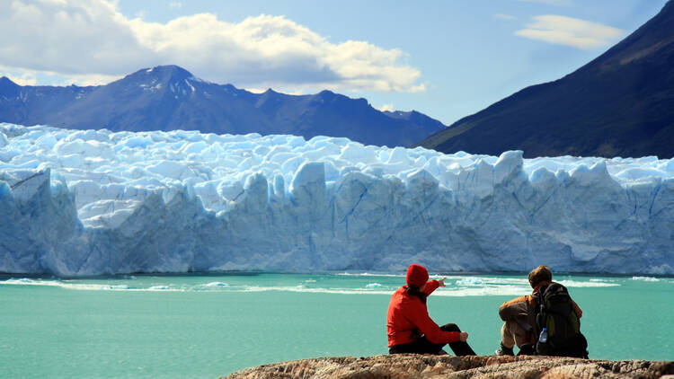 A couple look at a glacier