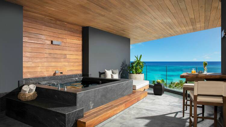View of the sea from a balcony with a hot tub