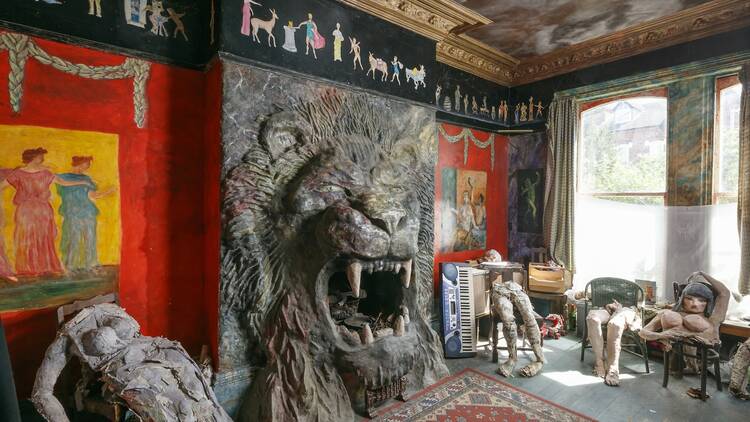 The living room of Ron's Place has a giant lion fireplace
