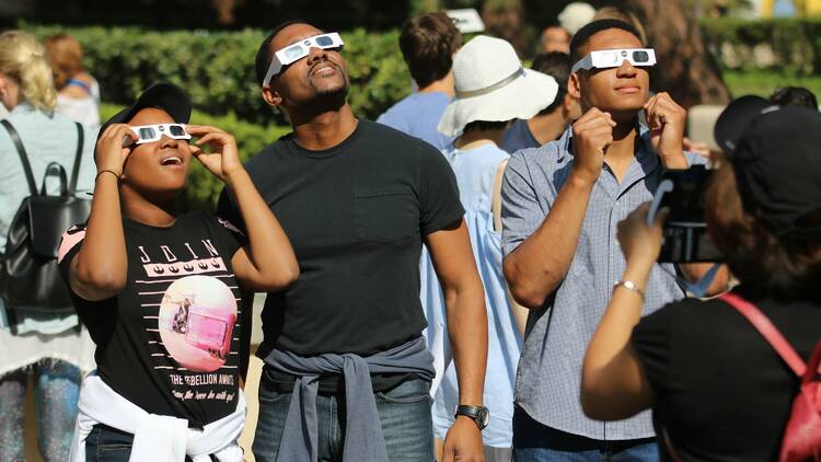 People looking at a solar eclipse