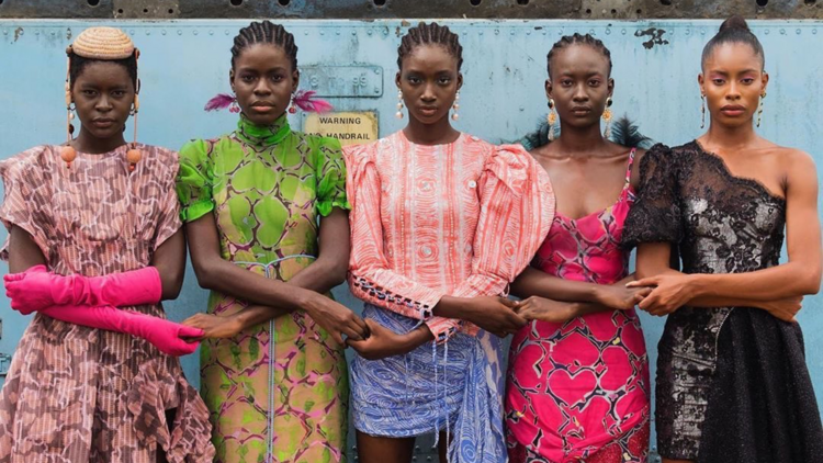 Models holding hands wearing colourful clothes in Lagos, Nigeria