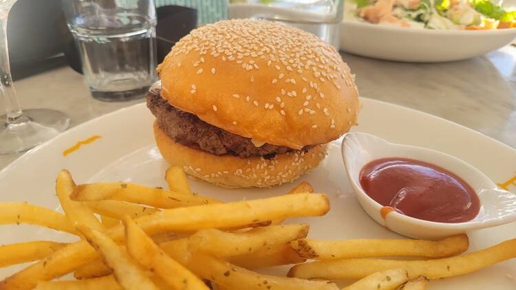 A hamburger and fries on a plate.