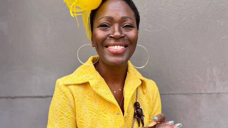 A woman in yellow clothing with a yellow headpiece.