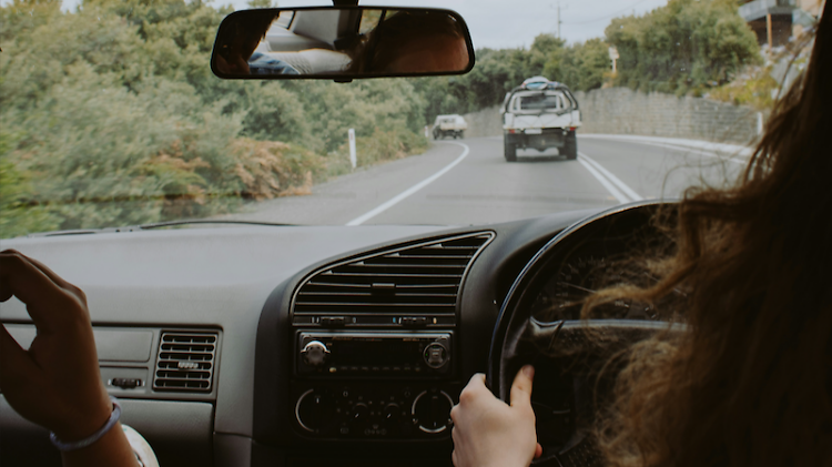 A view from inside a car out onto the road ahead. 