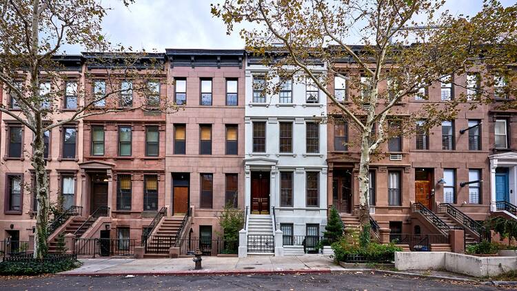 a view of a row of historic brownstones in an iconic neighborhood of Manhattan, New York Cit