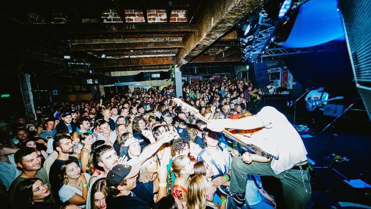 Crowd cheering for a live act on the stage 