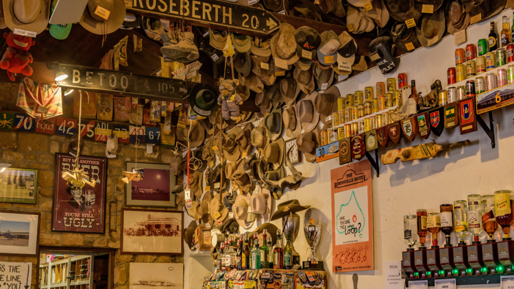 Pub wall filled with hanging hats