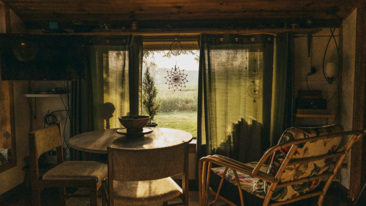 Dining table by a shaded window in the countryside cottage holiday rental in New Buffalo