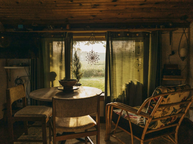 Dining table by a shaded window in the countryside cottage holiday rental in New Buffalo