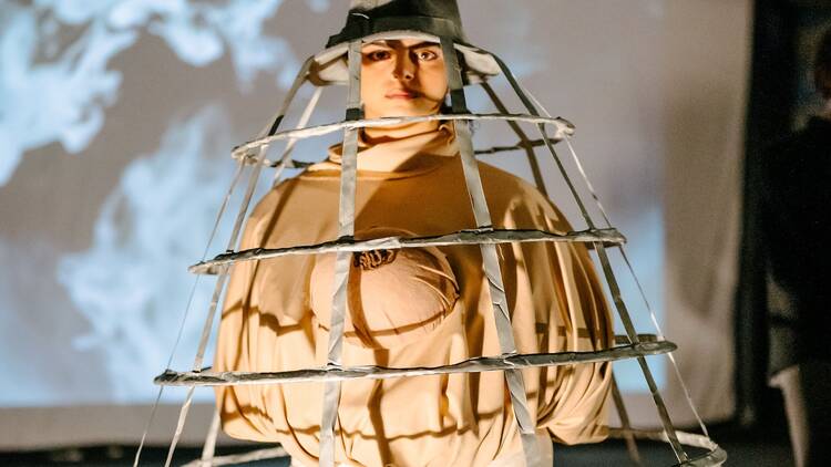 a performer in a cage