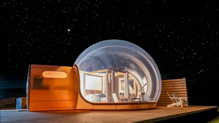 The bubble bedroom lit up with the star-lit sky in the background. 