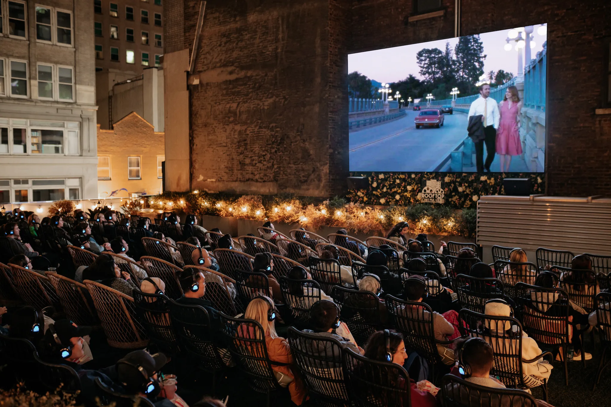 People watch a movie at Rooftop Cinema Club.