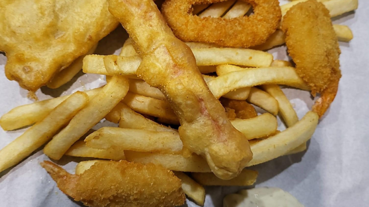 Fried fish and chips on takeaway paper