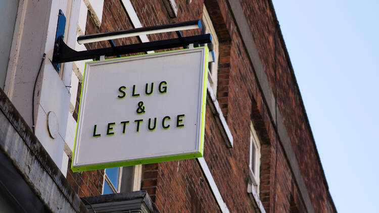 An image of a slug and lettuce hanging sign