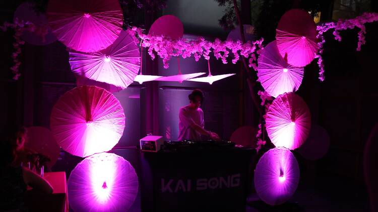 a dj in a purple night glow