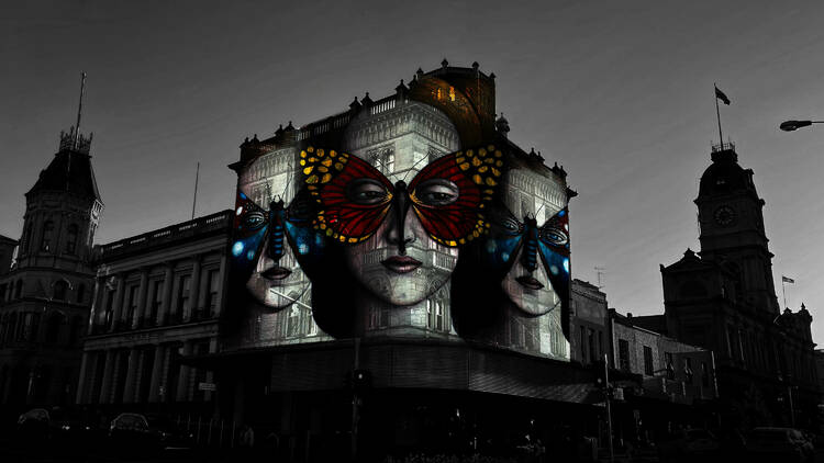 Decorated Ladies projection of three ladies with faces covered by butterflies