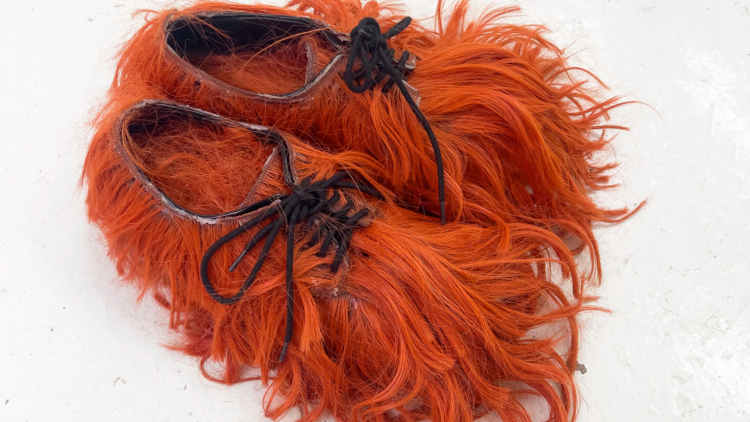 A pair of shoes made from red hair