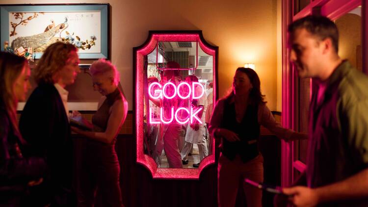 A pink sign at Good Luck Restaurant Lounge