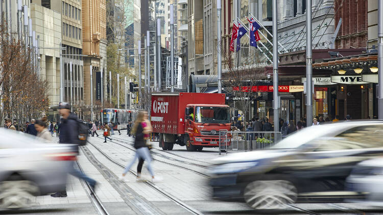 Australia Post box truck on a busy George Street in Sydney CBD