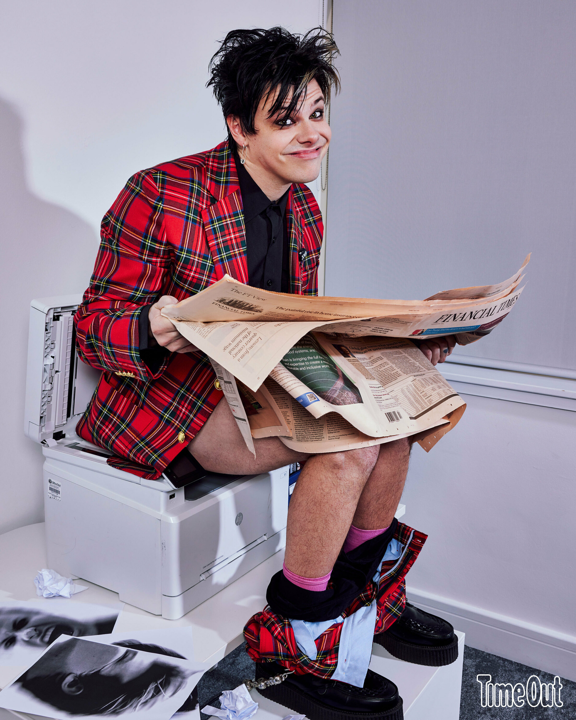 Yungblud sitting on a photocopier