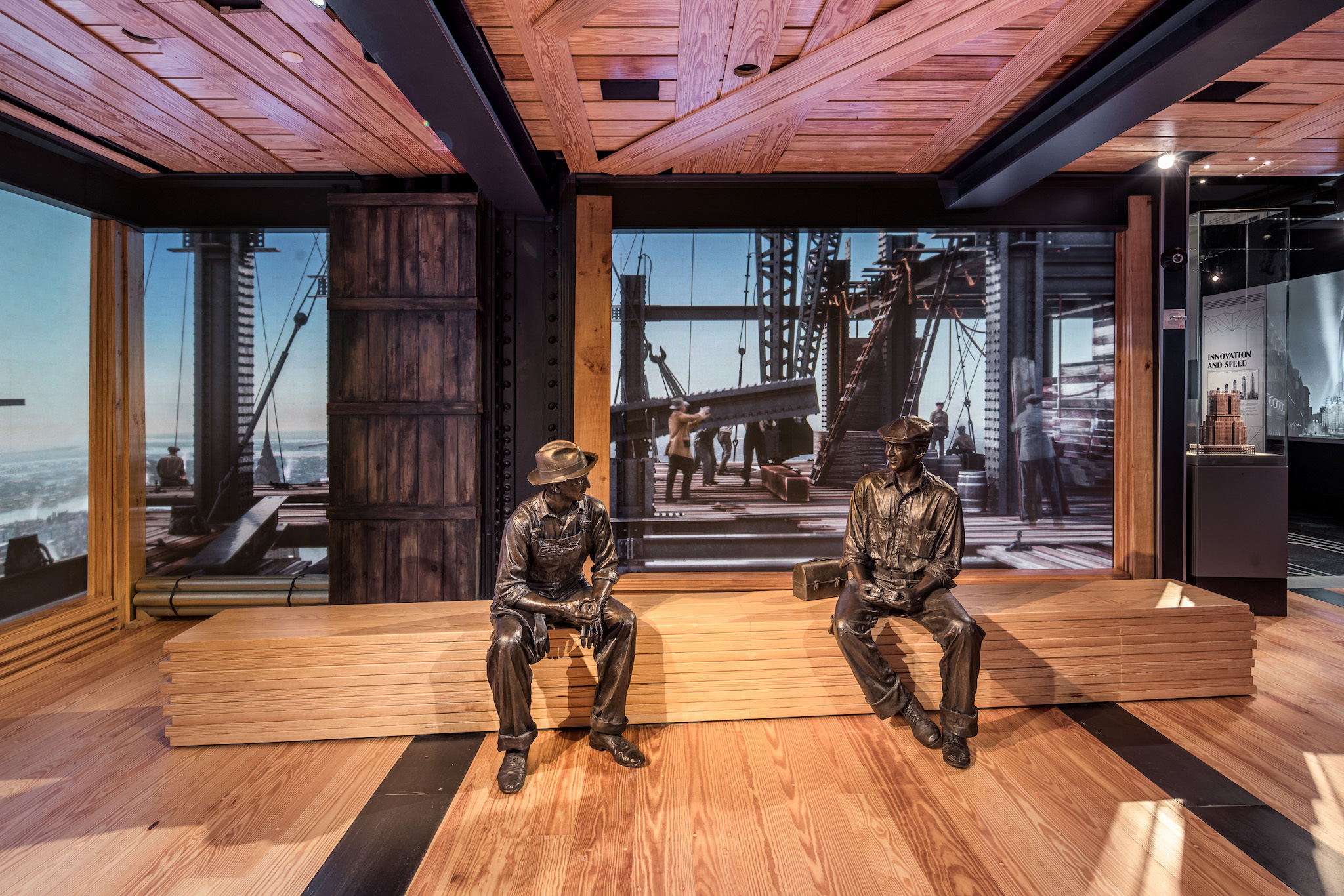 A history exhibit showing statues of two workmen.