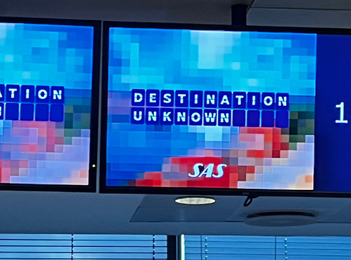 ’Destination Unknown’ sign at airport