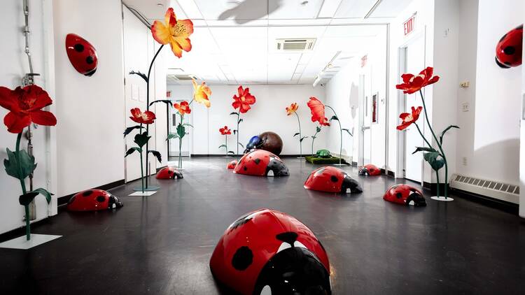 Giant ladybug sculptures inside IMAGINARI.