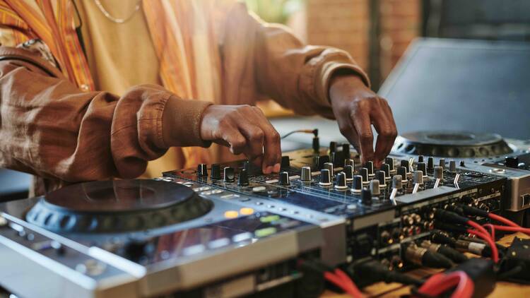 A DJ operating a sound mixer