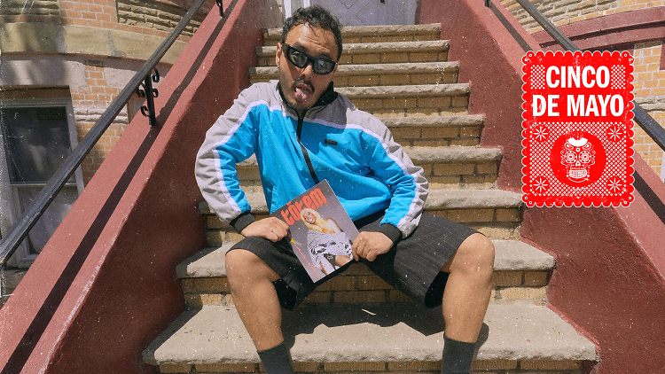 A person sits on a set of stairs holding a copy of Totem magazine.