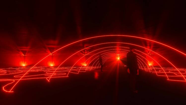 A intricate design of red lights in a large room.
