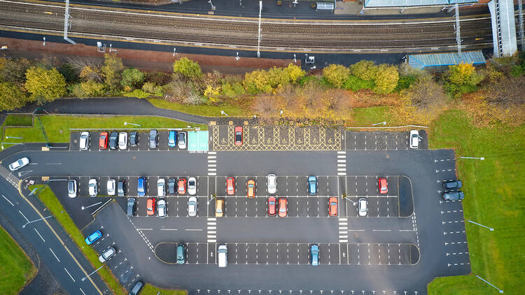 Aerial view of a railway station and car park