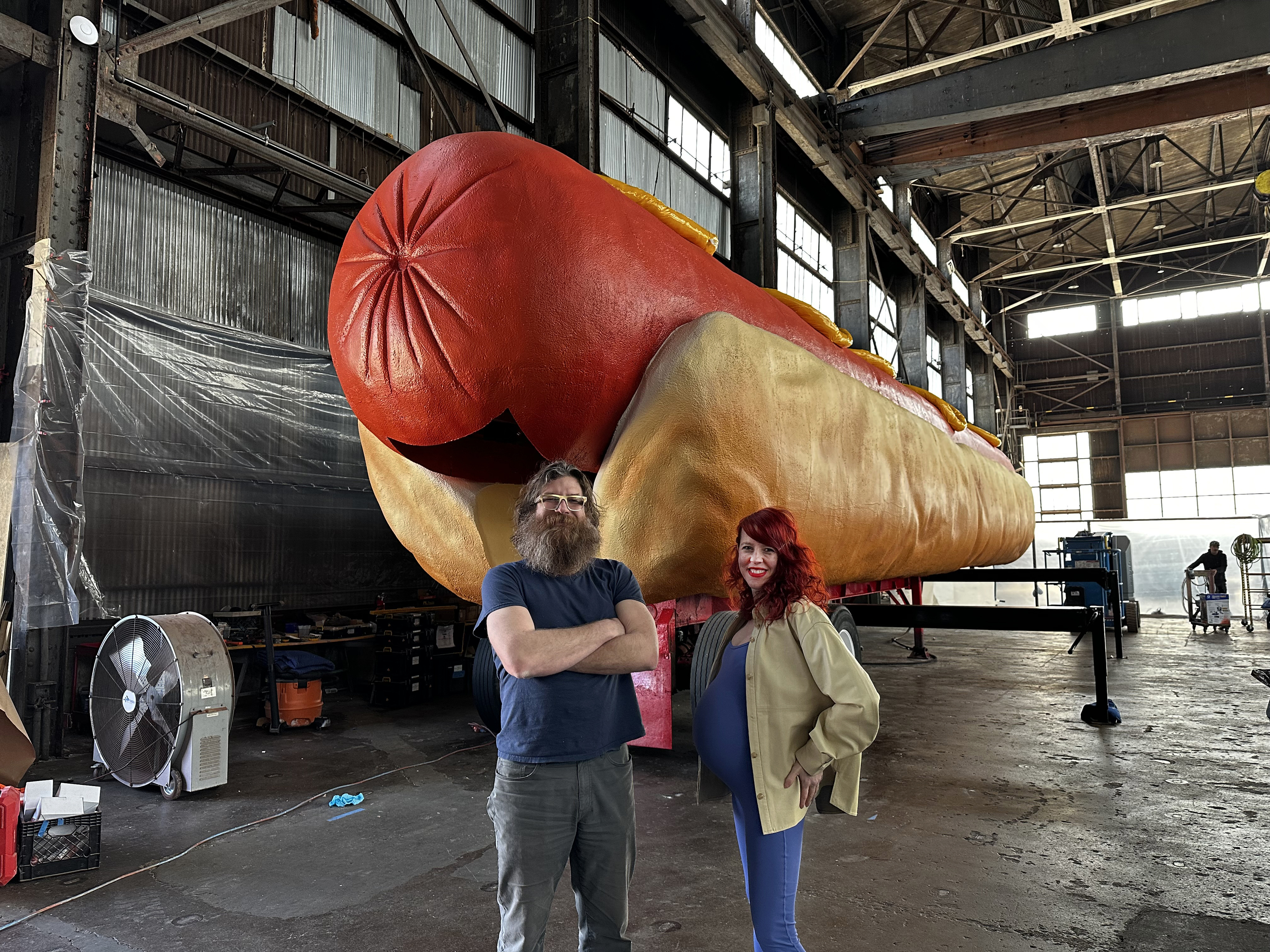 Jen Catron and Paul Outlaw in front of the giant hot dog
