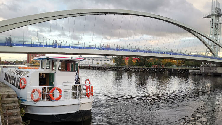 a riverboat docked on the riverside in Manchester