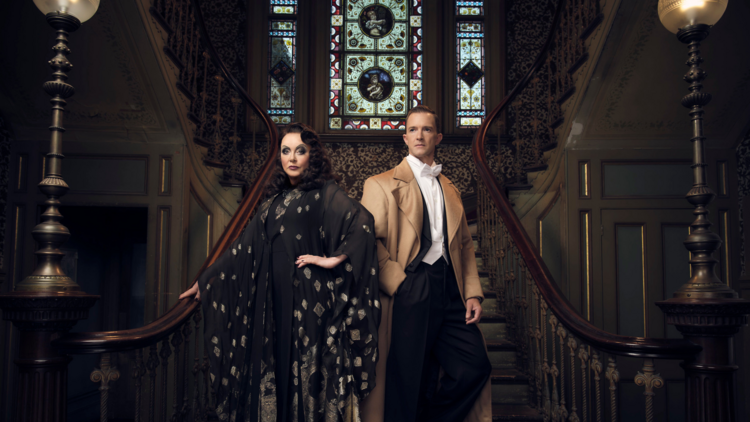 Sarah Brightman and Tim Draxl in costume in front of a stained glass window