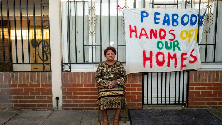 A woman sat in front of her home on Lesnes estate