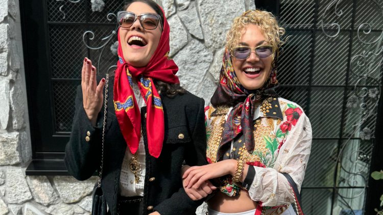 Two women wearing vintage outfits