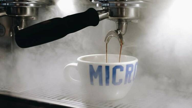 Cup of coffee being poured by machine