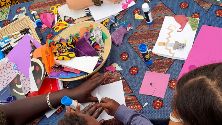 Kids glueing decorations onto pages