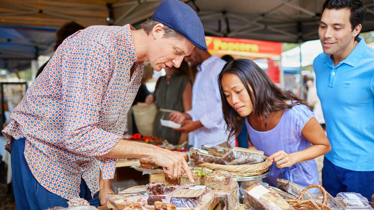 Man looking at baked goods at market