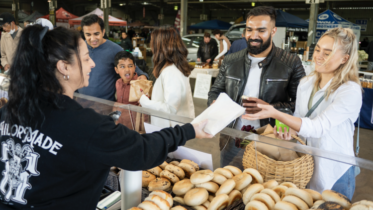 Couple ordering bagels at farmers market