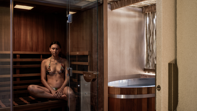 Girl in sauna with ice bath next door