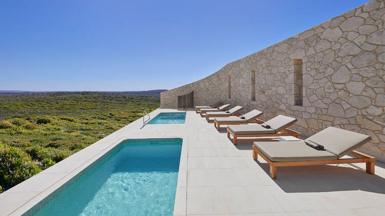 Hotel terrace with pool and lounge chairs